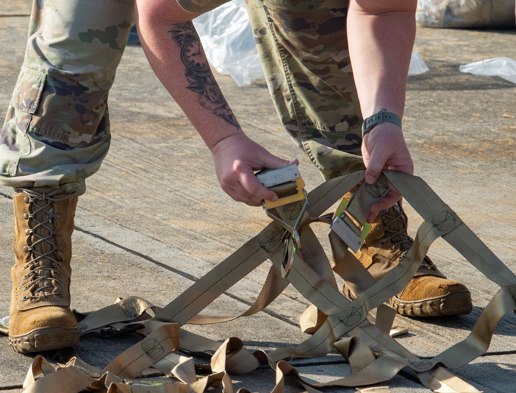 U.S. Air Force Staff Sgt. Megan Morgan, 23rd Logistics Readiness Squadron air transportation function noncommissioned officer in charge, unravels equipment straps during Exercise Ready Tiger 24-1 at Moody Air Force Base, Georgia, April 8, 2024.  During Ready Tiger 24-1, the 23rd Wing will be evaluated on the integration of Air Force Force Generation principles such as Agile Combat Employment, integrated combat turns, forward aerial refueling points, multi-capable Airmen, and combat search and rescue capabilities. (U.S. Air Force photo by Airman 1st Class Iain Stanley)