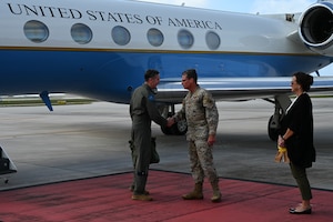 An Airman shakes another Airman's hand.