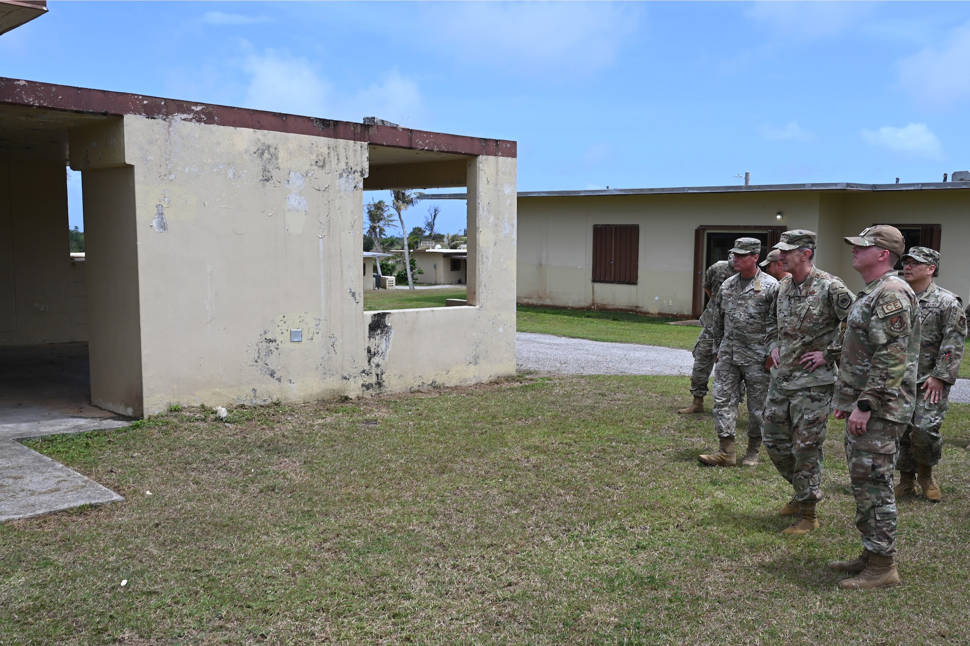 Airmen looks at damaged houses.