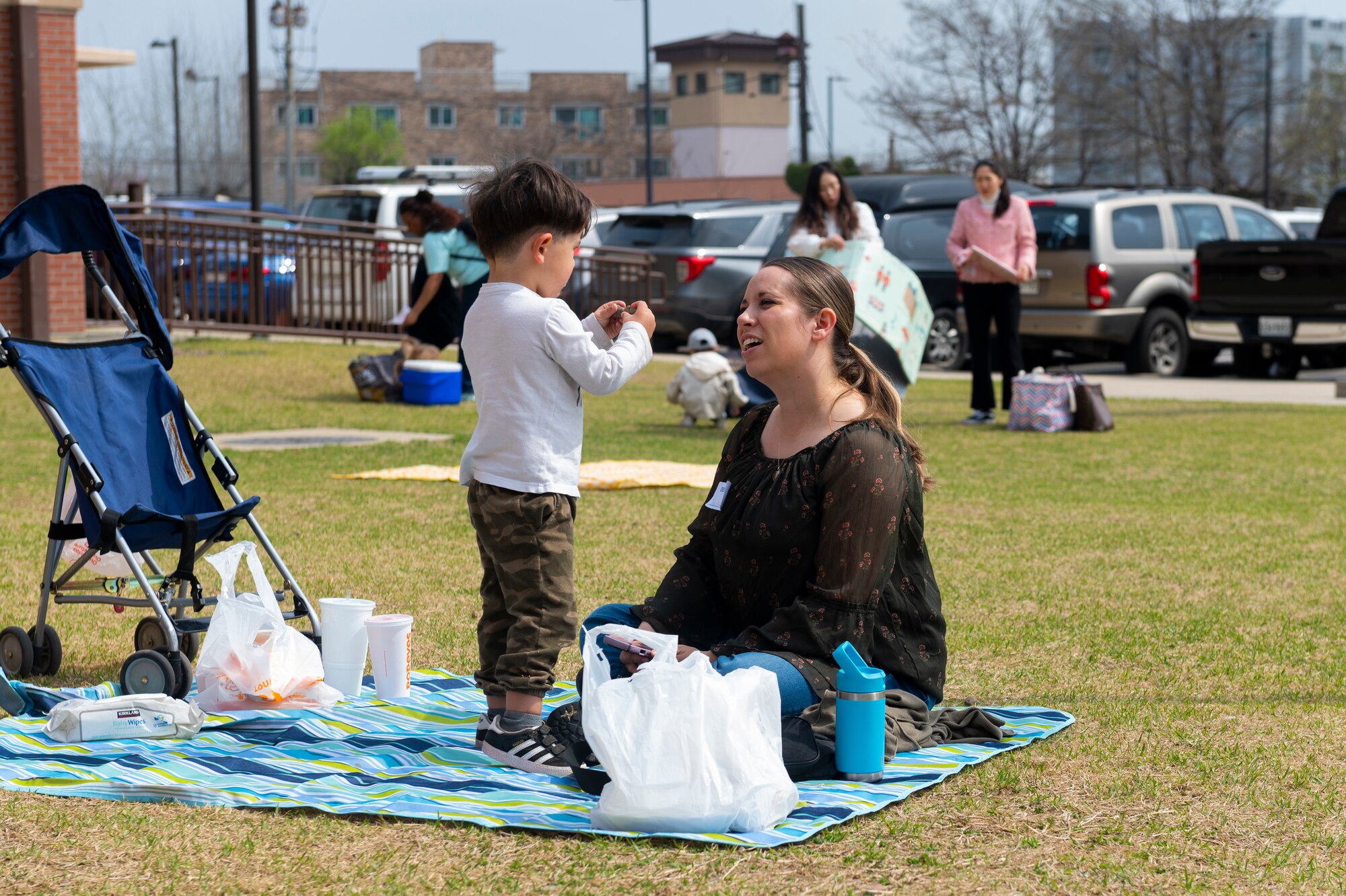 Tracy El-Khoury, U.S. Air Force military spouse, and her child participate in the Month of the Military Child picnic at Osan Air Base, Republic of Korea, April 10, 2024. MotMC is celebrated annually to honor the resilience of children in military families. (U.S. Air Force photo by Senior Airman Kaitlin Frazier)