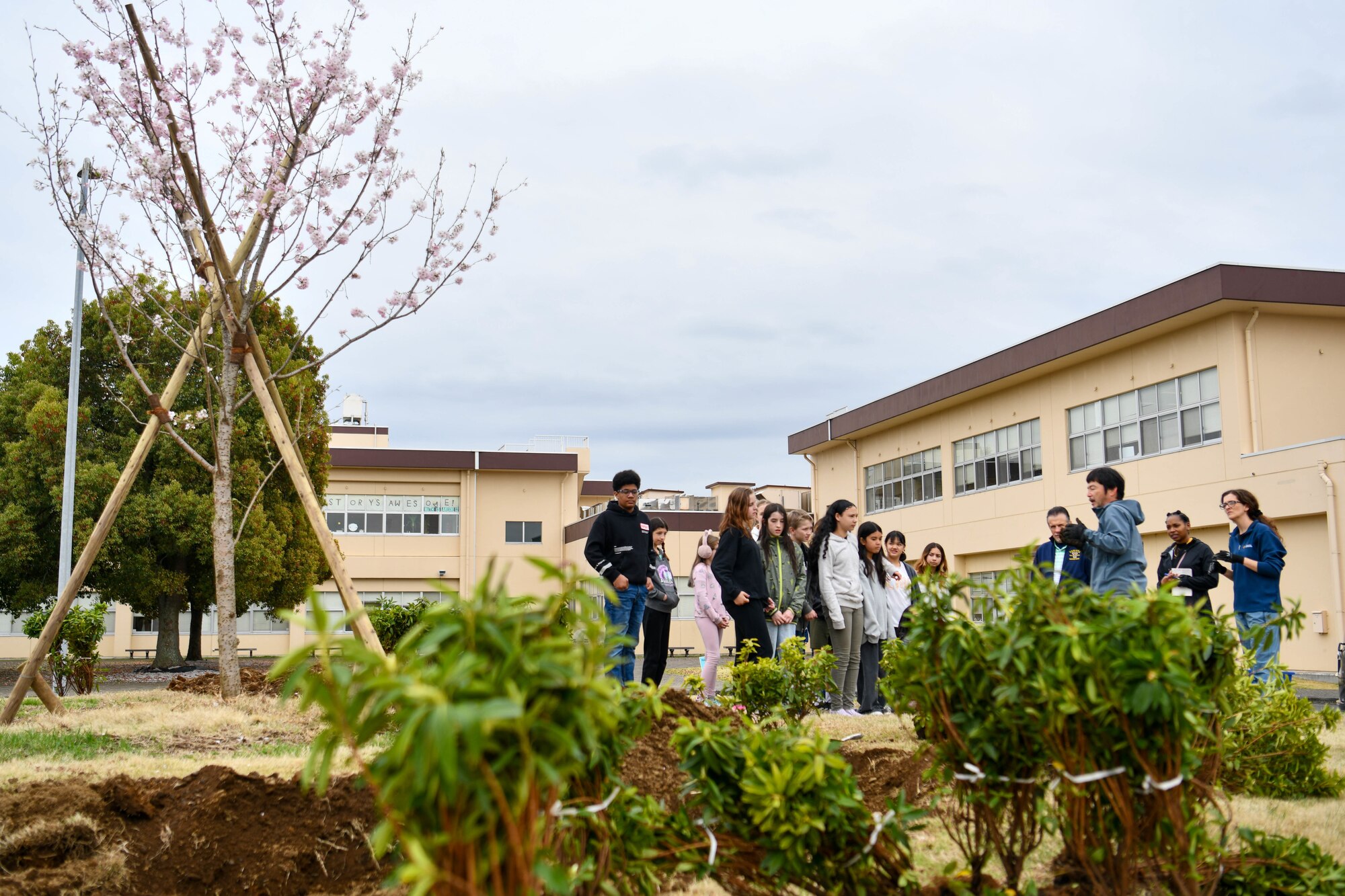 Students receive flower-planting instructions.