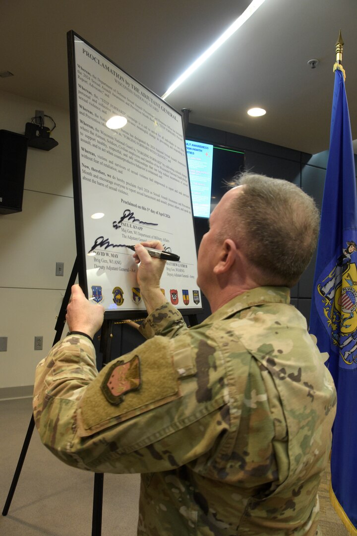 Brig. Gen. David May, Wisconsin’s deputy adjutant general for Air, signs a large copy of a proclamation during an April 2 kickoff event commemorating Sexual Assault Awareness and Prevention Month in the Wisconsin National Guard. The theme for this year’s campaign is “Forging Forward with Change” and reflects the work required to cultivate a culture in which everyone plays an active role in identifying and preventing sexual misconduct. Wisconsin Department of Military Affairs photo by Vaughn R. Larson