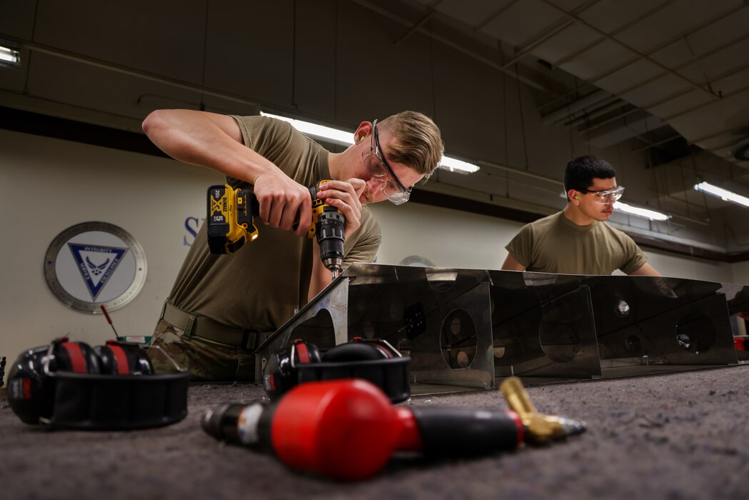 U.S. Air Force Airman Aidin Young, 9th Maintenance Squadron aircraft structural maintenance apprentice, drills a hole in a simulated aircraft structure on Beale Air Force Base, California, Dec. 19, 2023.