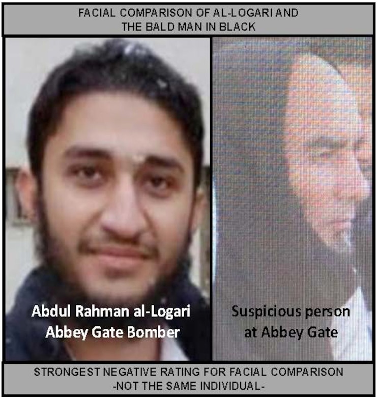 The faces of two men are side by side. The face on the left has a beard, is looking directly into the camera, and is almost smiling. The face on the right is a profile shot of a bald man in a black shirt and matching black head scarf who is sitting surrounded by Afghan refugees while looking off camera to the right.