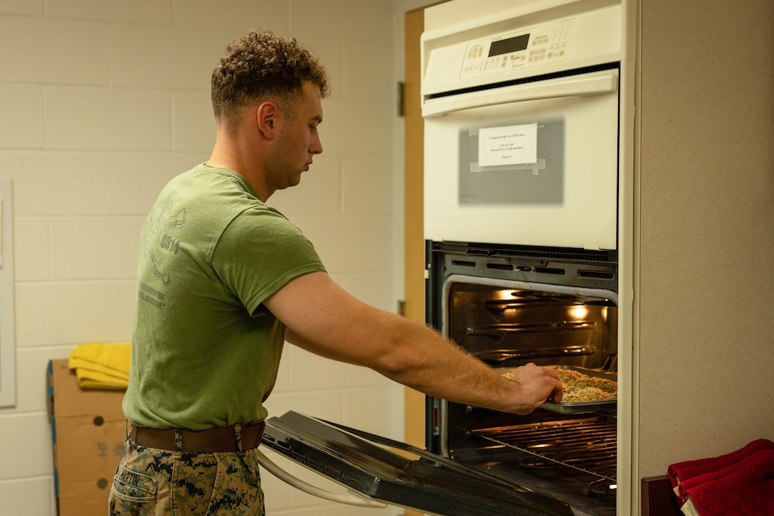 U.S. Marine Corps Sgt. Joshua Martin, a field artillery cannoneer with The Basic School, a Virginia, puts food into an oven during the Semper Fit Cooking Class at Barber Fitness Center on Marine Corps Base Quantico, Virginia, April 11, 2024. The class was held to teach Marines about the variety of healthy cooking options they can use to help maintain a balanced diet. (U.S. Marine Corps photo by Lance Cpl. Ethan Miller)