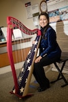 Dr. Anastasia Pike, plays the harp in the lobby of the Prostate Clinic at Walter Reed, April 5, 2024. Music has therapeutic properties that can improve mental health and emotional well-being.