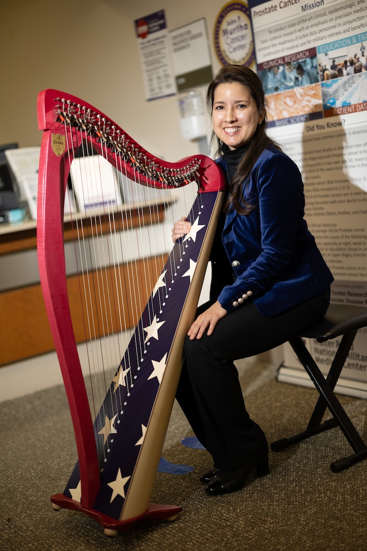 Dr. Anastasia Pike, plays the harp in the lobby of the Prostate Clinic at Walter Reed, April 5, 2024. Music has therapeutic properties that can improve mental health and emotional well-being.