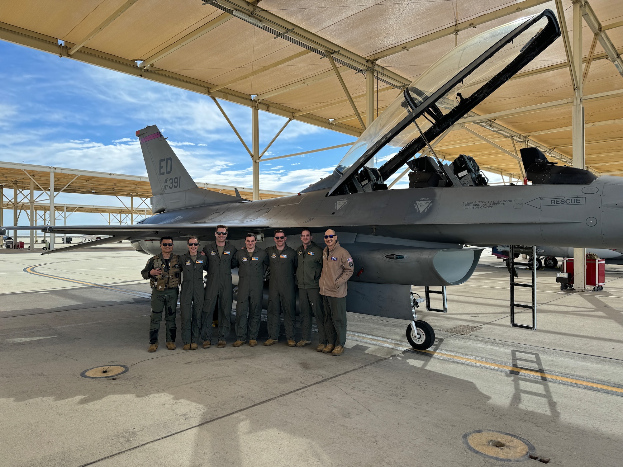 U.S. Air Force Test Pilot School students prepare to flight test the Integrated Cockpit Sensing, or ICS, system on an F-16 at Edwards Air Force Base, California, March 12, 2024. An Air Force Research Laboratory team developed the ICS system to provide an airworthy platform for comprehensive physiological, life-support and environmental monitoring to improve pilot safety and performance. The system has helmet-based, base layer and life- support sensors, ensuring holistic information on the pilot and operating environment during flight. (U.S. Air Force photo / Ethan Blackford)