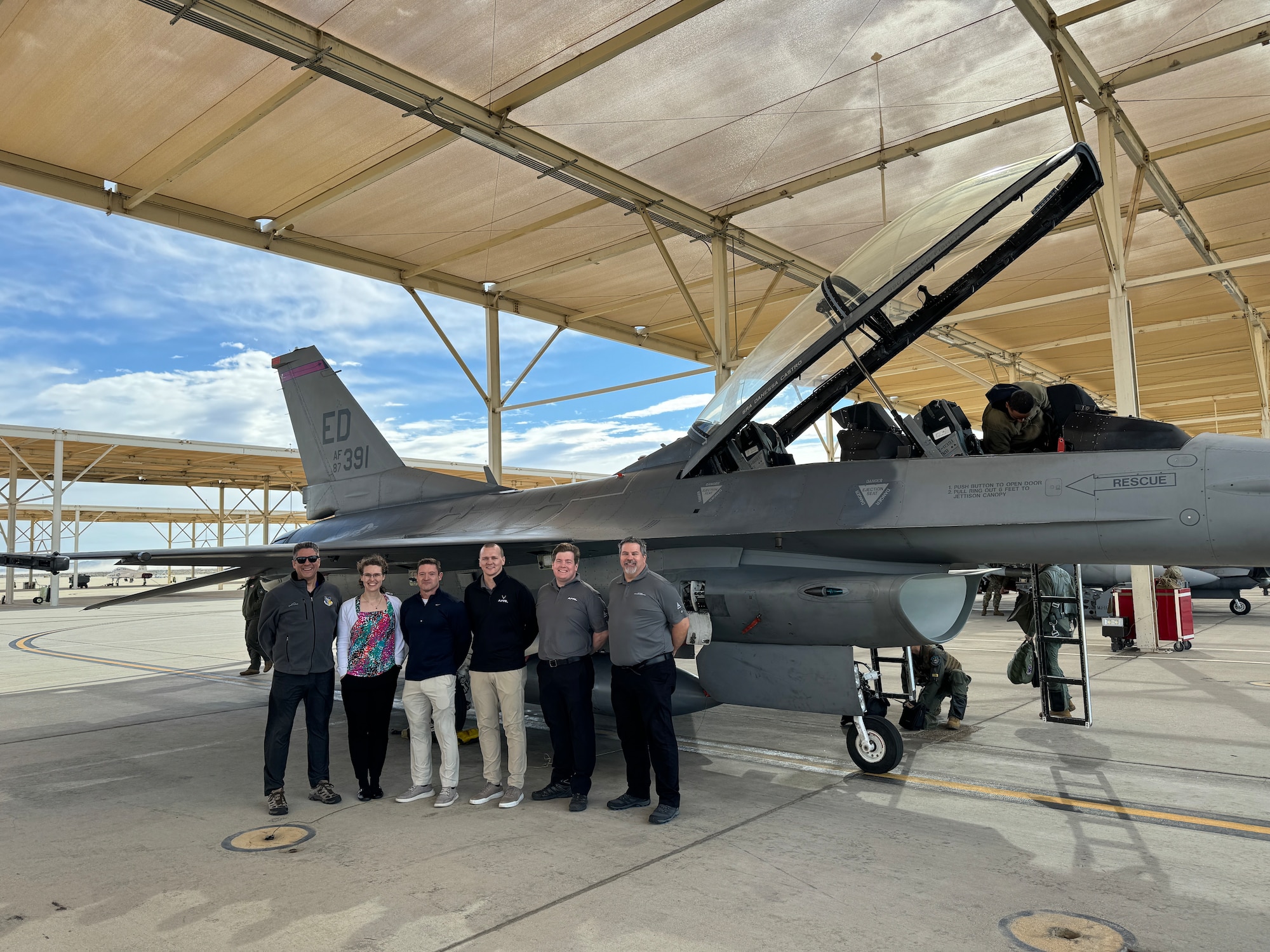 Air Force Research Laboratory, or AFRL, scientists and engineers prepare to watch U.S. Air Force Test Pilot School students test the Integrated Cockpit Sensing, or ICS, system on an F-16 at Edwards Air Force Base, California, March 12, 2024. An AFRL team developed the ICS system to provide an airworthy platform for comprehensive physiological, life-support and environmental monitoring to improve pilot safety and performance. The system has helmet-based, base layer and life-support sensors, ensuring holistic information on the pilot and operating environment during flight. (U.S. Air Force photo / Wei Lee)