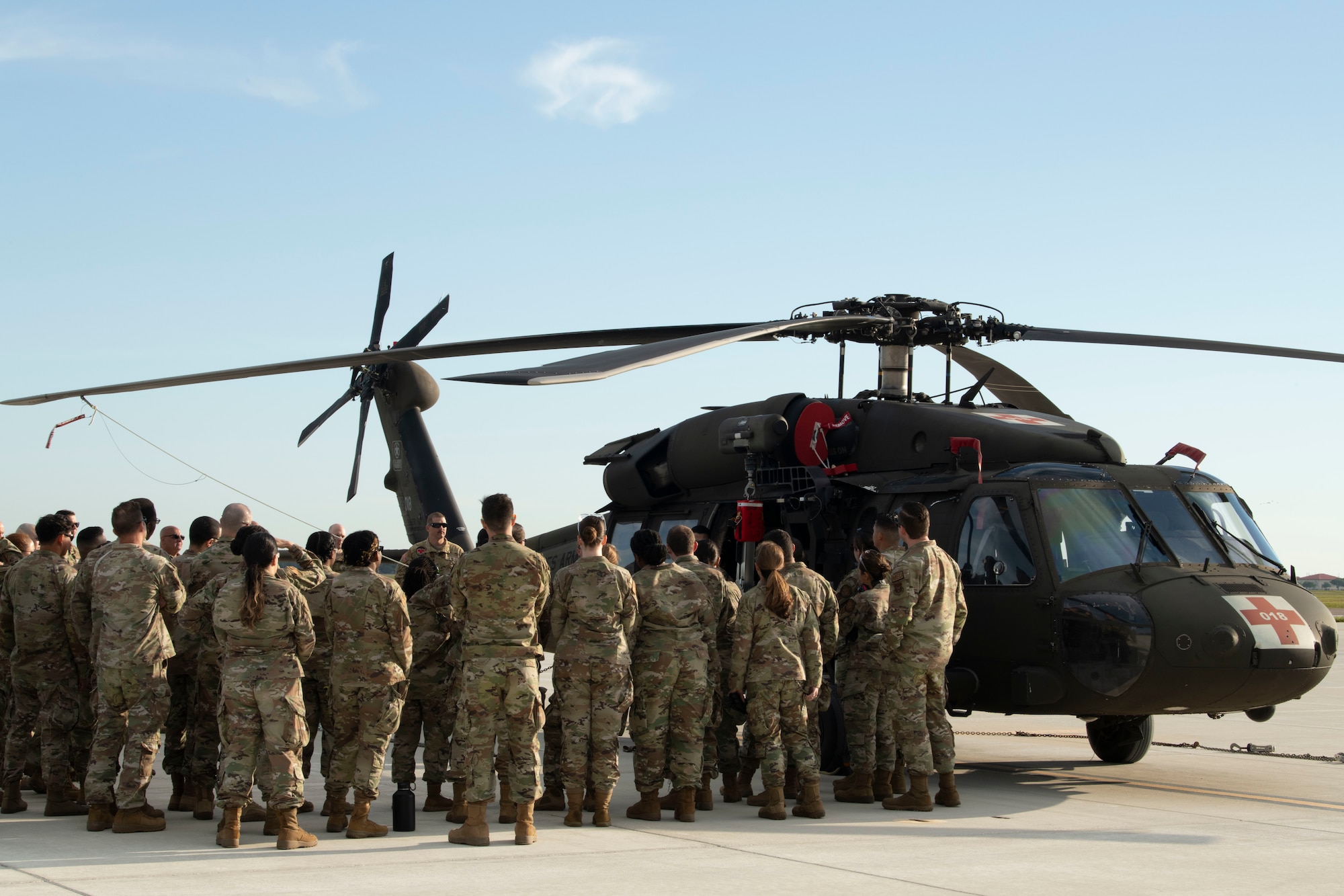 927th Aeromedical Staging Squadron Airmen gather around a 5th Battalion, 159th Aviation Regiment UH-60 Black Hawk helicopter to receive a safety and information briefing on MacDill Air Force Base, Florida, April 6, 2024. The 927th ASTS partnered with the 5-159th to conduct Black Hawk and aeromedical evacuation familiarization training. (U.S. Air Force photo by Staff Sgt. Leah Ritchey)