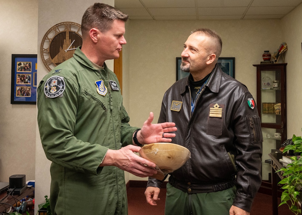U.S. Air Force Col. Paul Townsend, 354th Fighter Wing commander, gives wooden bowl gift to Italian Air Force Col. Vito Cracas, RED FLAG-Alaska Italian Detachment commander