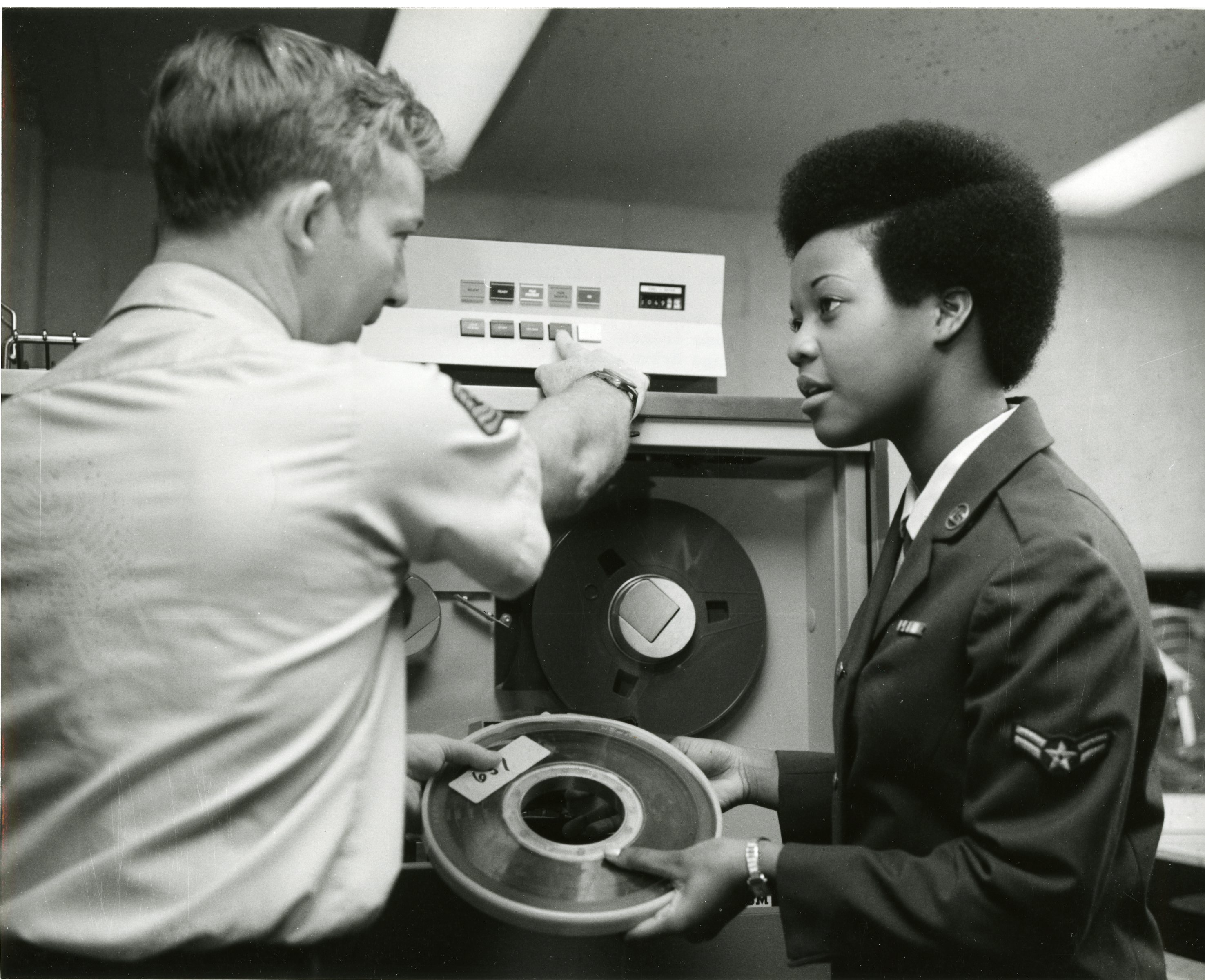 Airman First Class Terri Reynolds Discusses Procedures for Using the Tape Drive Machine