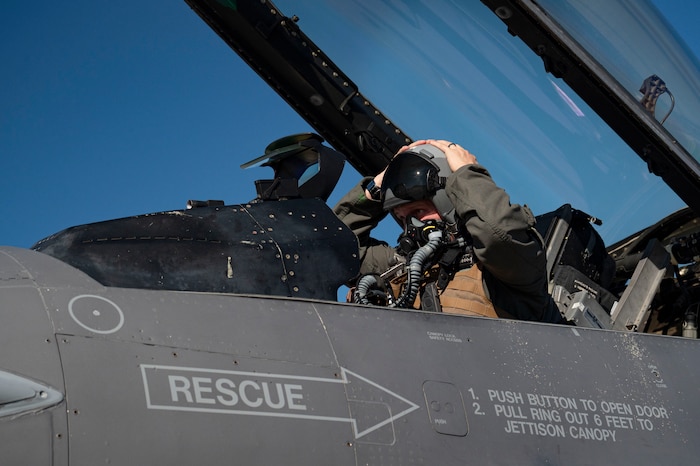 U.S. Air Force Lt. Col. Joshua Arnall, director of operations, 59th Test and Evaluation Squadron, prepares to flight test the Integrated Cockpit Sensing, or ICS, system on an F-16 at Nellis Air Force Base, Nevada, Jan. 30, 2024. An Air Force Research Laboratory team developed the ICS system to provide an airworthy platform for comprehensive physiological, life-support and environmental monitoring to improve pilot safety and performance. (U.S. Air Force photo / Senior Airman Megan Estrada)