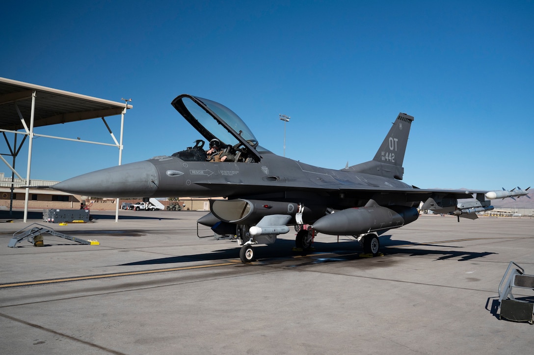 U.S. Air Force Lt. Col. Joshua Arnall, director of operations, 59th Test and Evaluation Squadron, prepares to flight test the Integrated Cockpit Sensing, or ICS, system on an F-16 at Nellis Air Force Base, Nevada, Jan. 30, 2024. An Air Force Research Laboratory team developed the ICS system to provide an airworthy platform for comprehensive physiological, life-support and environmental monitoring to improve pilot safety and performance. (U.S. Air Force photo / Senior Airman Megan Estrada)