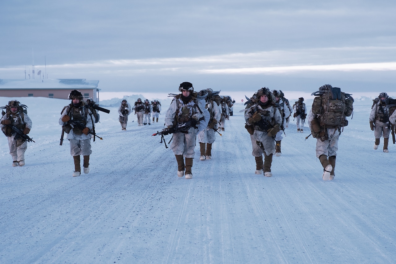 Soldiers patrol across an icy tundra.