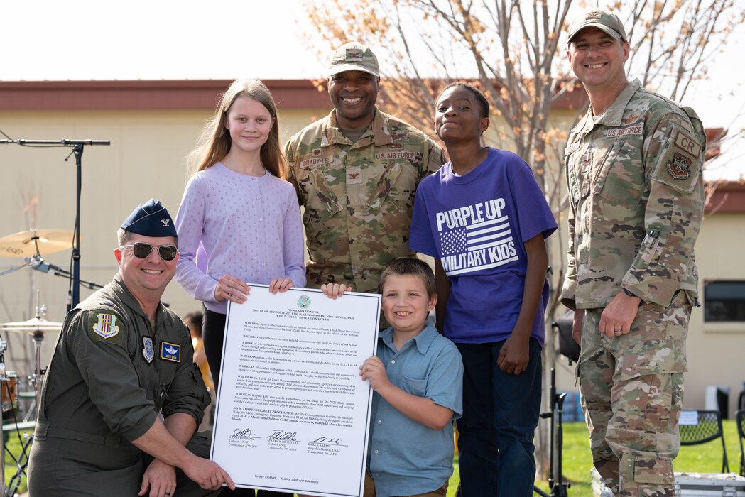 A group photo of Airmen and military children