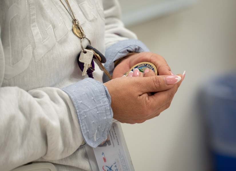 A photo of a woman holding a coin.