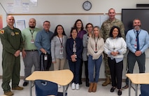 A photo of a several people posing for a photo.