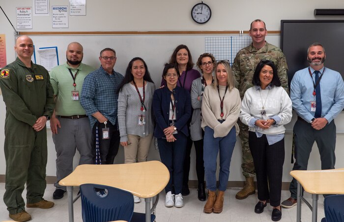 A photo of a several people posing for a photo.