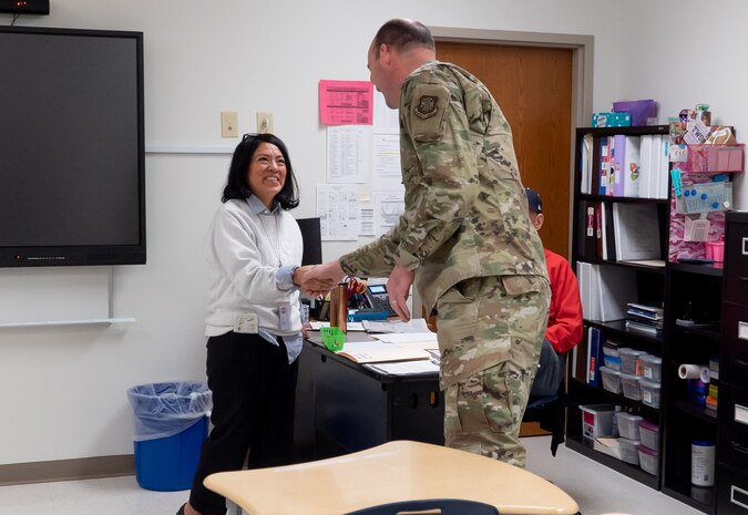 A photo of a man and woman shaking hands.