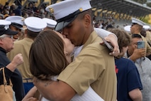 A new U.S. Marine from Mike Company, 3rd Recruit Training Battalion, is greeted by a guest after a graduation ceremony at Marine Corps Recruit Depot San Diego, California, April 12, 2024. Graduation took place at the completion of the 13-week transformation, which included training for drill, marksmanship, basic combat skills, and Marine Corps customs and traditions. (U.S. Marine Corps photo by Cpl. Alexander O. Devereux)