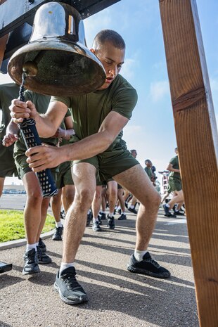 A U.S. Marine with Mike Company, 3rd Recruit Training Battalion, rings the 3rd Battalion liberty bell at Marine Corps Recruit Depot San Diego, California, April 11, 2024. The company motivational run is the last physical training event the Marines will conduct before they graduate from MCRD San Diego. (U.S. Marine Corps photo by Sgt. Jesse K. Carter-Powell)