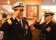 Rear Adm. Greg Newkirk salutes sideboys as he arrives to the Commander, Task Force (CTF) 70 and Carrier Strike Group 5 change of command ceremony at U.S. Fleet Activities Yokosuka, April 12. CTF 70 is forward-deployed to the U.S. 7th Fleet area of operations in support of security and stability in the Indo-Pacific region. (U.S. Navy photo by Mass Communication Specialist 1st Class James R. Mitchell)