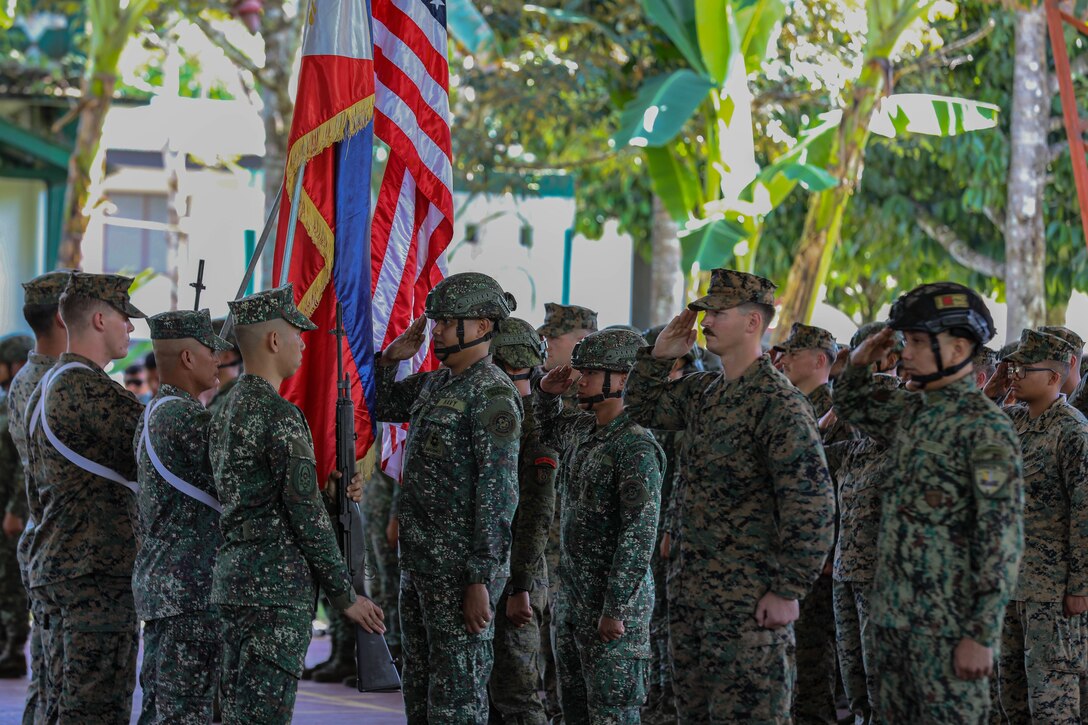 U.S. Marines and Armed Forces of the Philippines service members salute during the opening ceremony of Marine Exercise 2024 near Cotabato City, Mindanao, Philippines, April 8, 2024. MAREX 2024 is a bilateral exercise between the U.S. Marine Corps and the Philippine Marine Corps designed to further enhance relationships, interoperability, and combined arms capabilities in a realistic training environment. (U.S. Marine Corps photo by Lance Cpl. Andrew Whistler)