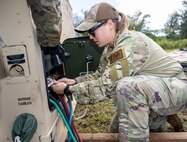 U.S. Air Force 1st Lt. Taylor Howe, the Tinian spoke mayor assigned to the 3rd Air Expeditionary Wing out of Joint Base Elmendorf-Richardson, Alaska, tightens lugs on a voltage reconnection panel in order to supply power to the camp during Exercise Agile Reaper 24-1 at Tinian Forward Operating Site, Northern Mariana Islands, April 9, 2024. AR 24-1 is a 3rd Wing-initiated exercise that focuses on Agile Combat Employment and employs a hub-and-spoke concept of operations with Tinian FOS serving as one of the four disaggregated spokes working under the hub situated at Andersen Air Force Base, Guam. The exercise employs combat-representative roles and processes to deliberately target all participants as a training audience and stress the force’s capability to generate combat air power in an expeditious manner across the Indo-Pacific Region. (U.S. Air Force photo by Tech. Sgt. Curt Beach)