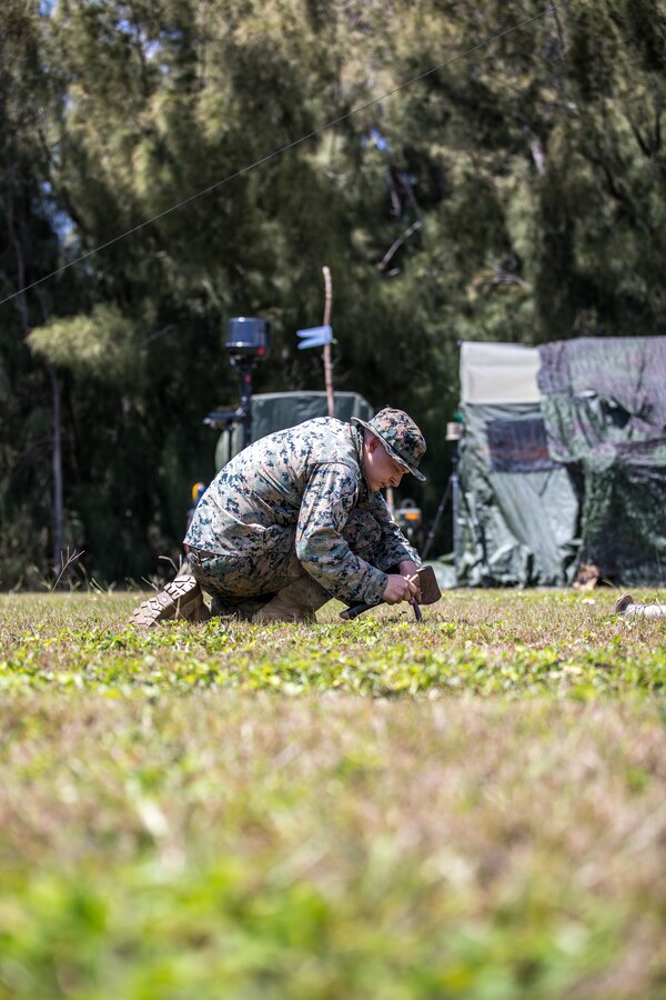 U.S. Marine Corps Cpl. Logan Navock, an intelligence surveillance reconnaissance systems engineer with 3rd Radio Battalion, III Marine Expeditionary Force Information Group, assembles a field expedient antenna during a signal intelligence operation at Camp H.M. Smith, Hawaii on April 9, 2024. The rehearsal trained Marines to collect simulated enemy electronic signals while reducing their own during exercise Corvus Dawn 24 battalion operations. CD24 sharpened 3rd RADBN's ability to provide technical information related capabilities to III Marine Expeditionary Force and the joint and multi-national force throughout the Indo-Pacific region. Novack is a native of Michigan. (U.S. Marine Corps photo by Staff Sgt. Samuel Ruiz)
