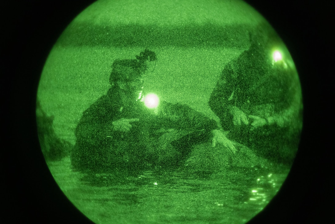 A U.S. Marine Radio Reconnaissance Operator Course student, conducts a radio reconnaissance amphibious infiltration during a Radio Reconnaissance Operators Course at Joint Base Pearl Harbor-Hickam, Hawaii on March 25, 2024. The course served as an intense training evolution, prioritizing skill refinement and acted as the preliminary phase for exercise Corvus Dawn 24 battalion operations. CD24 sharpened 3rd Radio Battalion's ability to provide technical information related capabilities to III Marine Expeditionary Force and the joint and multi-national force throughout the Indo-Pacific region. (U.S. Marine Corps photo by Cpl. Bridgette Rodriguez)