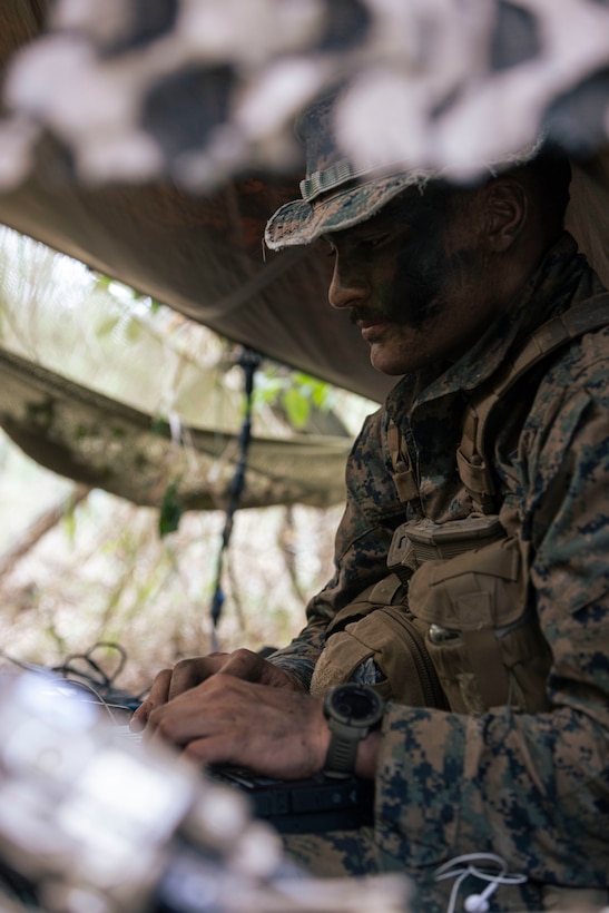 A U.S. Marine Radio Reconnaissance Operator Course student, analyzes the simulated opposing force’s cellular signature during an intelligence collection operation at Bellows Air Force Station, Hawaii on April 3, 2024. The rehearsal served to test the radio reconnaissance Marines’ ability to intercept the simulated opposing force’s communication signals and collect intelligence in the preliminary phase of exercise Corvus Dawn 24 battalion operations. CD24 sharpened 3rd Radio Battalion's ability to provide technical information related capabilities to III Marine Expeditionary Force and the joint and multi-national force throughout the Indo-Pacific region. (U.S. Marine Corps photo by Cpl. Bridgette Rodriguez)