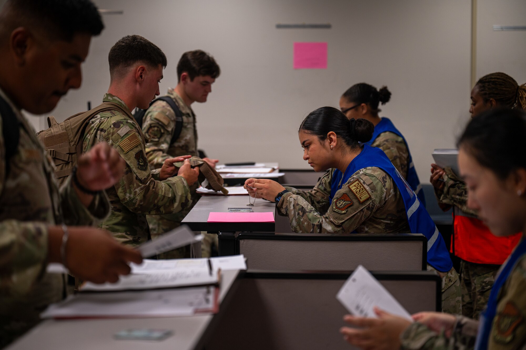 Team Hickam personnel check documentation for a pre-deployment line.