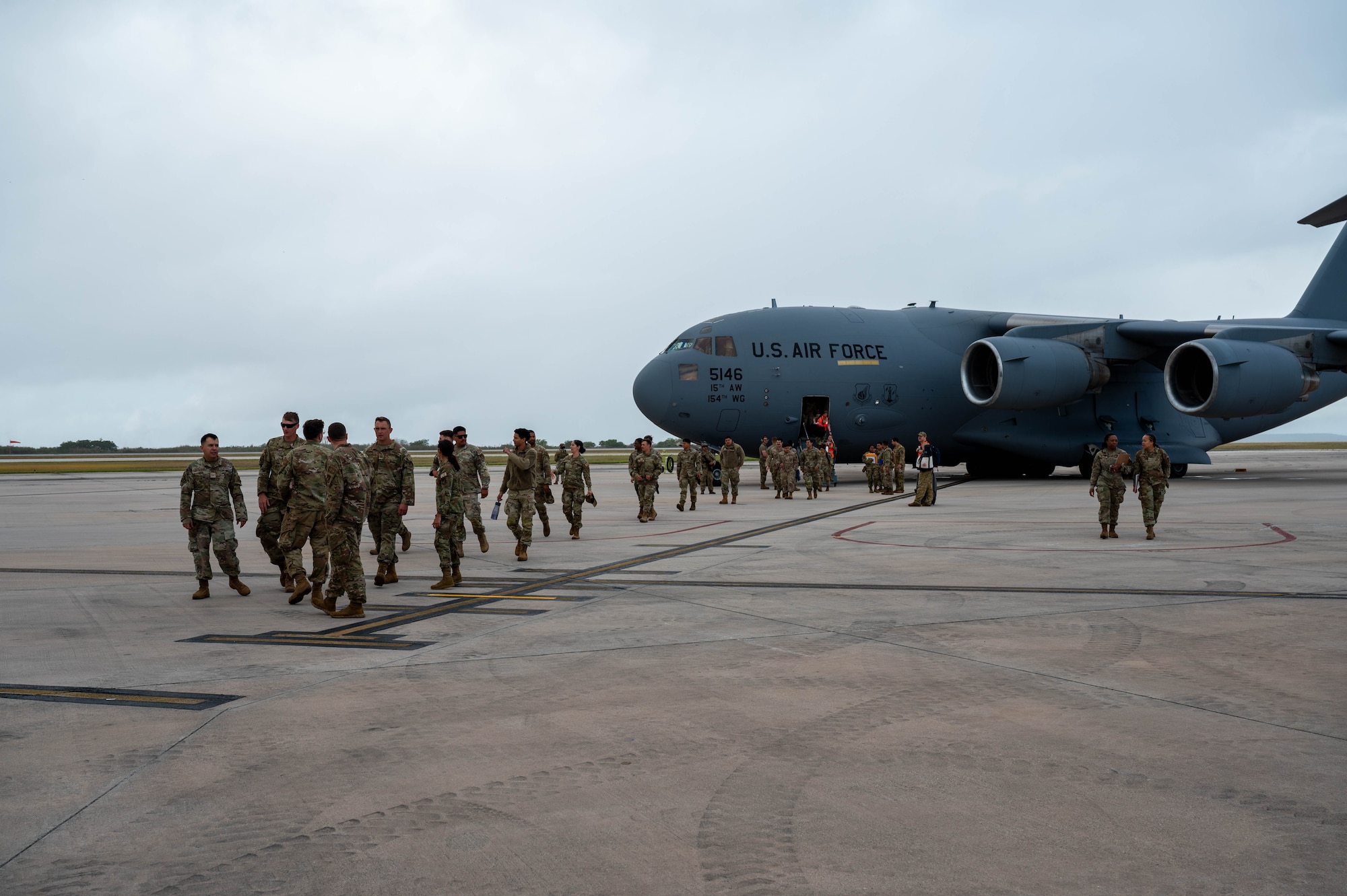 New arrivals deplane from a C-17 Globemaster III during Exercise Agile Reaper 24-1 in Saipan, North Mariana Islands, 6 April, 2024). Approximately 250 personnel from three locations traveled to participate in training within an environment where they can operate at the level of stress that will increase responsiveness to natural disasters and other challenges to better support the Pacific. (Photo by U.S. Air Force Technical Sgt. Tarelle Walker)