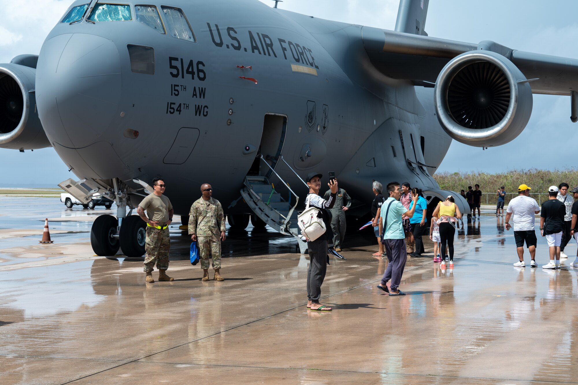 People attending a community day event hosted by the 15th Wing and 3rd Air Expeditionary Wing explore a C-17 Globemaster III at Saipan, Northern Marianas, April 13, 2024. The event was held during Exercise Agile Reaper 24-1 and gave community members an opportunity to speak with Airmen and learn more about the aircraft and their capabilities. (U.S. Air Force photo by Senior Airman Mark Sulaica)