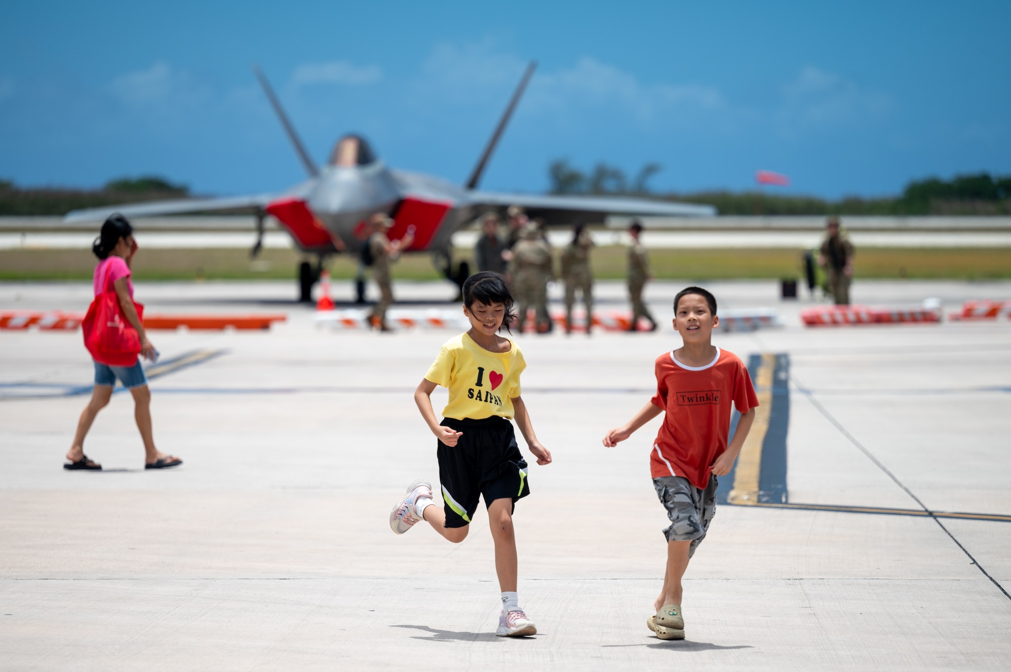 Children explore a community day event hosted by the 15th Wing and 3rd Air Expeditionary Wing at Saipan, Northern Marianas Islands, April 13, 2024. During the event participants explored three military aircraft and had the opportunity to talk to Airmen about their jobs and the capabilities of the aircraft. (U.S. Air Force photo by Senior Airman Mark Sulaica)