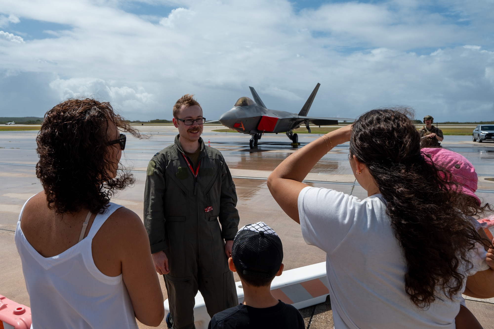 An Airman assigned to the 3rd Air Expeditionary Wing speaks to people during a community day at Saipan, Northern Mariana Islands on April 13, 2024. The event was held during Exercise Agile Reaper 24-1 and gave community members an opportunity to speak with Airmen and learn more about the aircraft and their capabilities. (U.S. Air Force photo by Senior Airman Mark Sulaica)