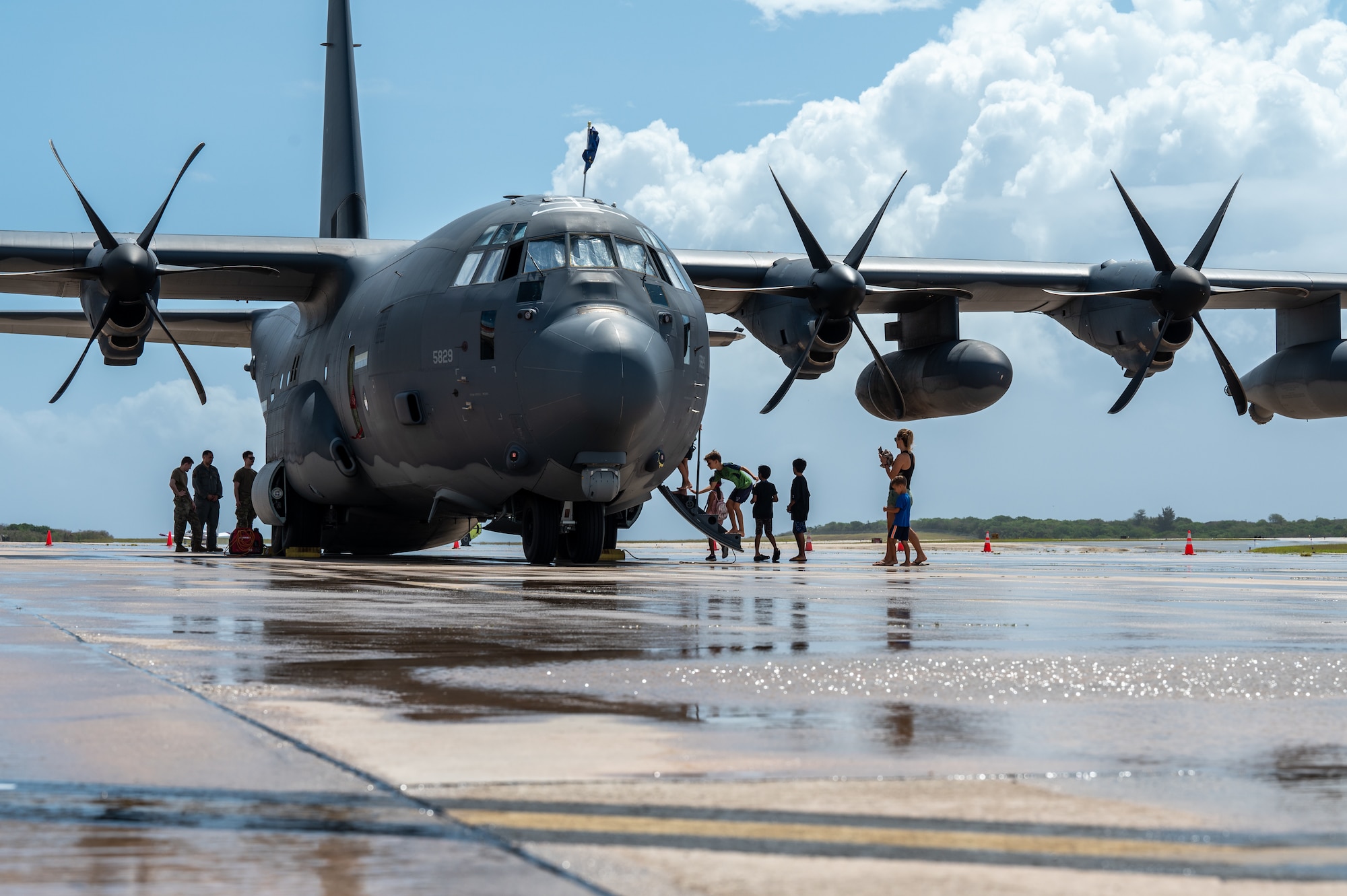 People attending a community day event explore a HC-130J Combat King II, at Saipan, Northern Marianas, April 13, 2024. Participants also had the chance to take photos with a static C-17 Globemaster III and a F-22 Raptor during the event. (U.S. Air Force photo by Senior Airman Mark Sulaica)