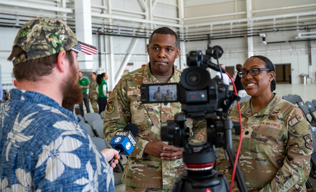 Logan Gaschler, left, a reporter with WBOC, asks U.S. Air Force Lt. Cols. Jerome Rogers, center, 512th Maintenance commander, and Sabrina Winter, right 436th Mission Generation Group deputy commander, questions after the Hangar 916 ribbon-cutting ceremony at Dover Air Force Base, Delaware, April 15, 2024. The ceremony was held to celebrate the completion of the $45 million project, promoting Dover AFB’s dedication to innovation. (U.S. Air Force photo by Airman 1st Class Amanda Jett)