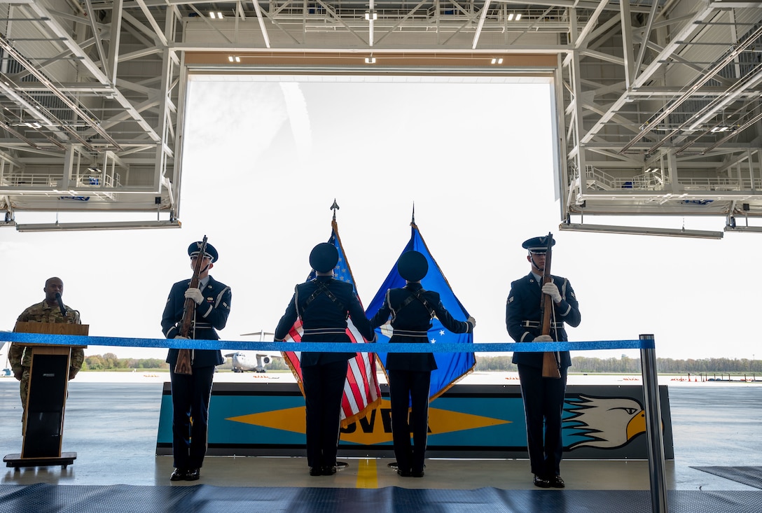 436th Airlift Wing Base Honor Guard adjusts ceremonial flags during a ribbon cutting ceremony at Dover Air Force Base, Delaware, April 15, 2024. The ceremony was held to celebrate the completion of the $45 million project, promoting Dover AFB’s dedication to innovation. (U.S. Air Force photo by Airman 1st Class Amanda Jett)