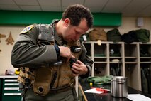 U.S. Air Force Lt. Col. Joshua Arnall, director of operations, 59th Test and Evaluation Squadron, adjusts the Integrated Cockpit Sensing, or ICS, system prior to flight testing at Nellis Air Force Base, Nevada, Jan. 30, 2024. An Air Force Research Laboratory team developed the ICS system to provide an airworthy platform for comprehensive physiological, life-support and environmental monitoring to improve pilot safety and performance. (U.S. Air Force photo / Senior Airman Megan Estrada)