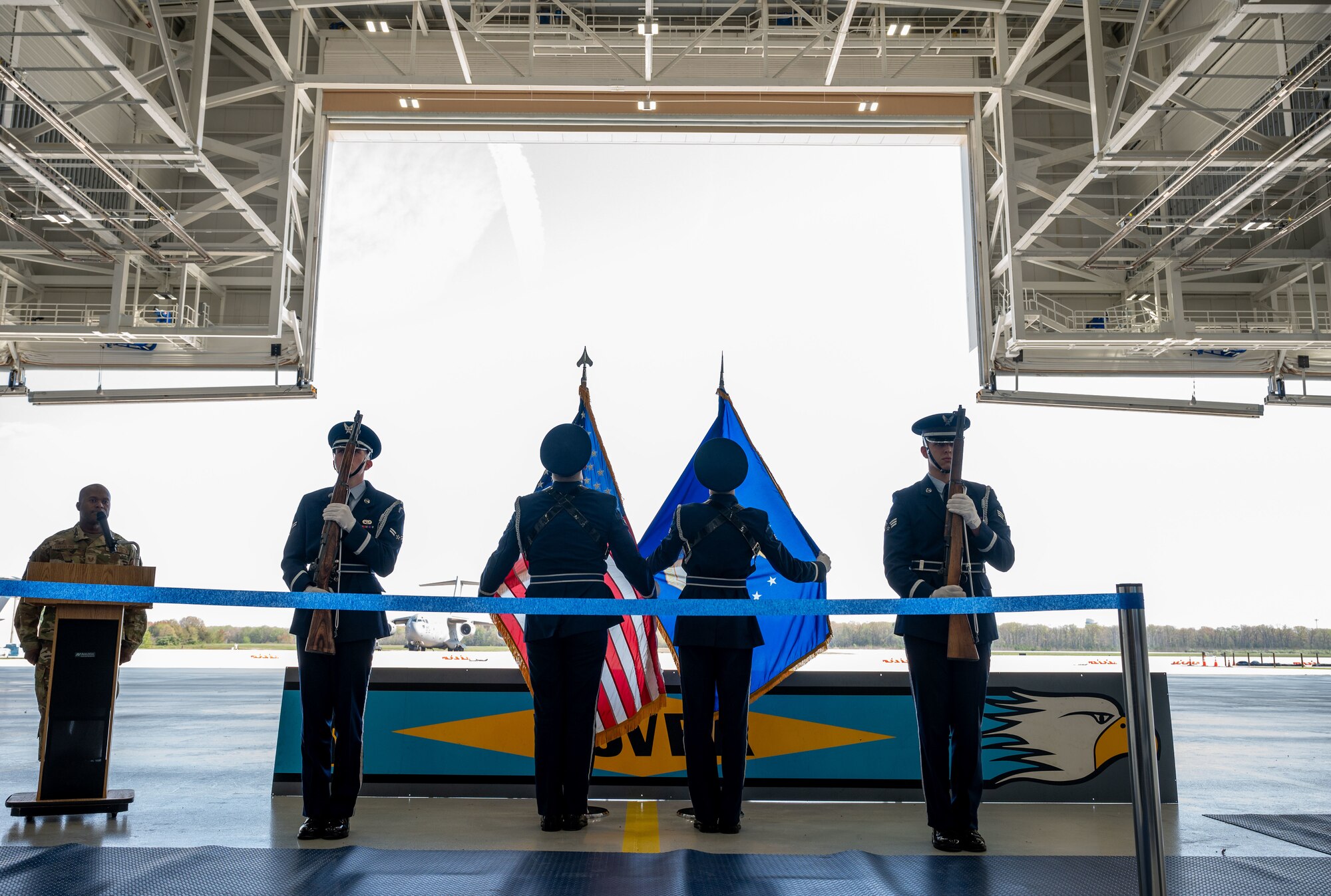 436th Airlift Wing Base Honor Guard adjusts ceremonial flags during a ribbon cutting ceremony at Dover Air Force Base, Delaware, April 15, 2024. The ceremony was held to celebrate the completion of the $45 million project, promoting Dover AFB’s dedication to innovation. (U.S. Air Force photo by Airman 1st Class Amanda Jett)