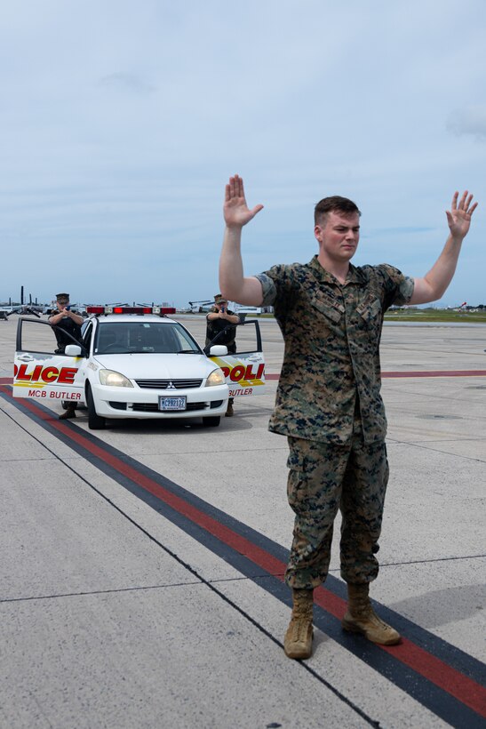 U.S. Marine Corps military police officers with the Provost Marshal’s Office, Headquarters and Support Battalion, Marine Corps Installations Pacific, detain a trespasser during a flight line breach training as part of exercise Resolute Response on Marine Corps Air Station Futenma, Okinawa, Japan, April 1, 2024. The exercise is a two-week training event to test base defenses through the enhanced response of the MCAS Futenma Emergency Operations Center. An EOC provides a commanding officer with single point command and control of installation facilities, resources, and support functions during an emergency in order to maintain situational awareness and support timely decision-making. (U.S. Marine Corps photo by Lance Cpl. Brody Robertson)