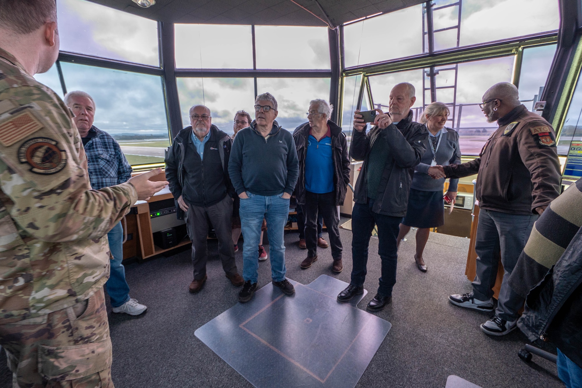 Greenham Common control tower volunteers participate in an immersion tour of the air traffic control tower.