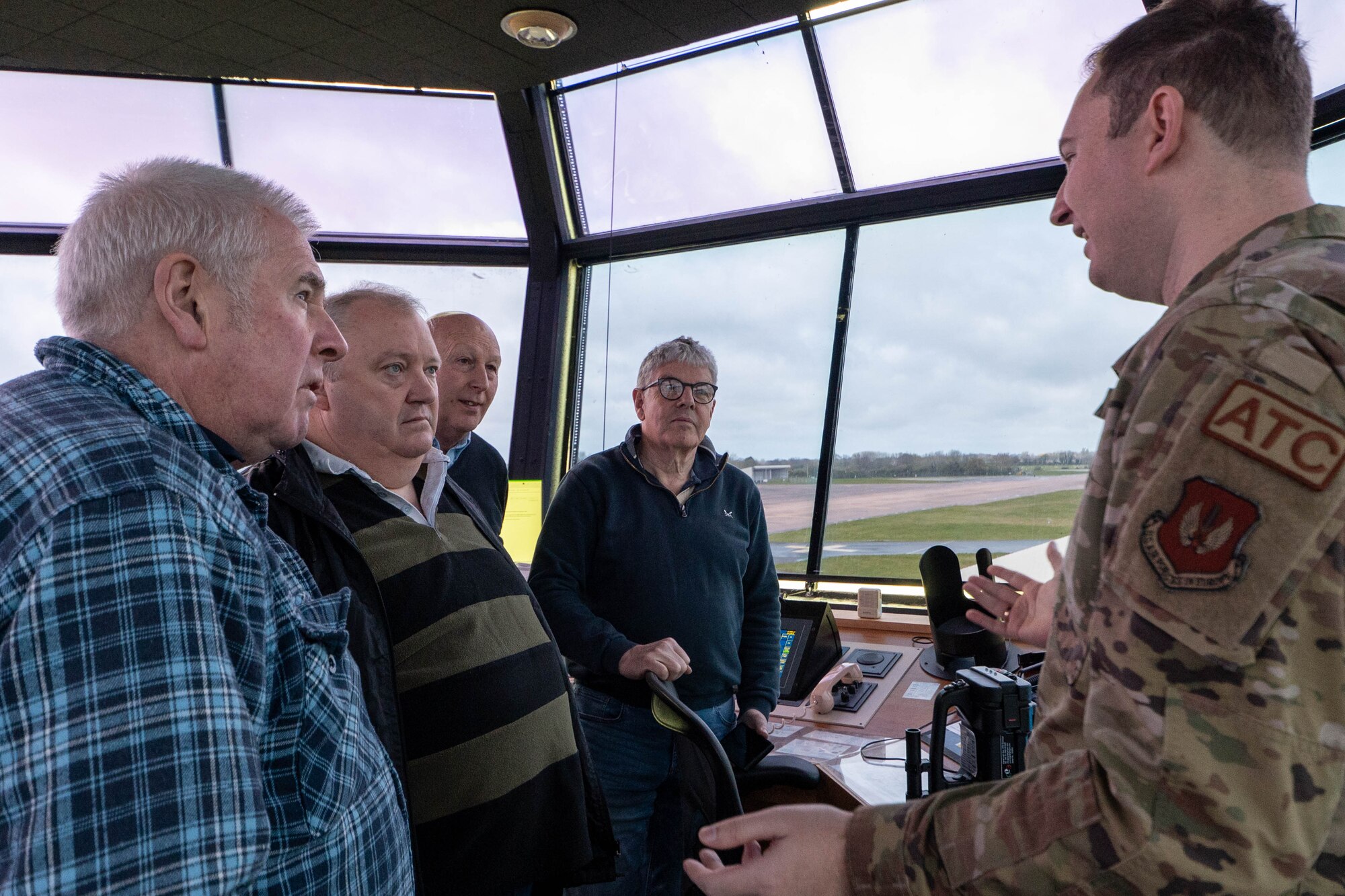 Greenham Common control tower volunteers participate in an immersion tour of the air traffic control tower.