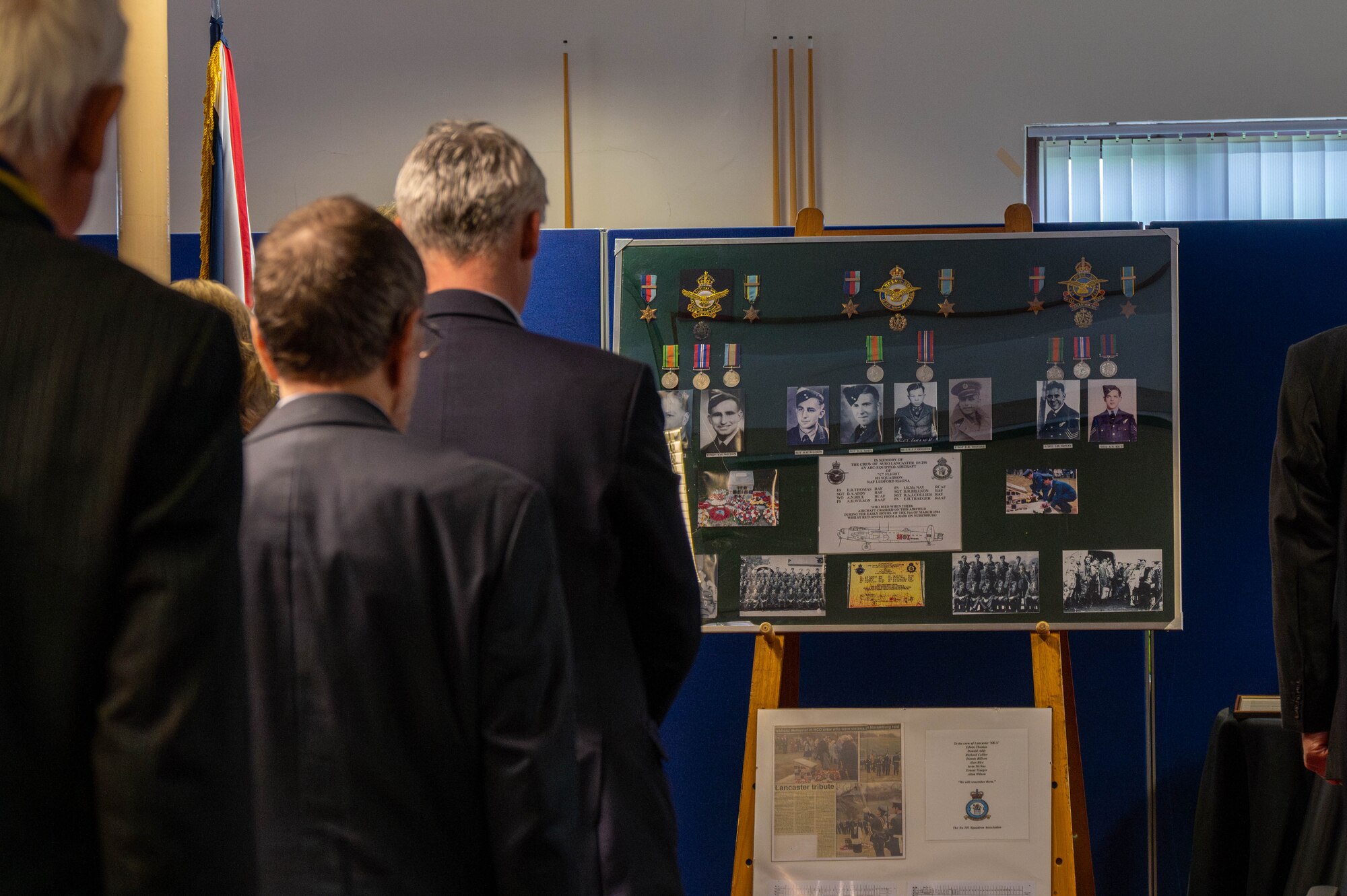 Members of the 501st Combat Support Wing and the local community .stand during a memorial service at RAF Welford