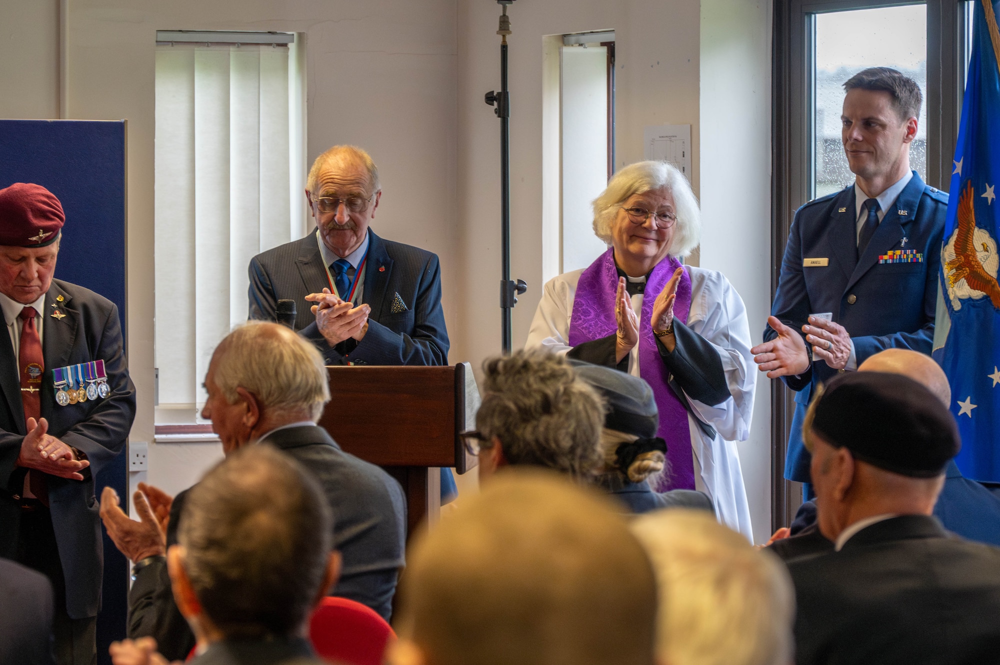 Members of the 501st Combat Support Wing and the local community applaud during a memorial service.