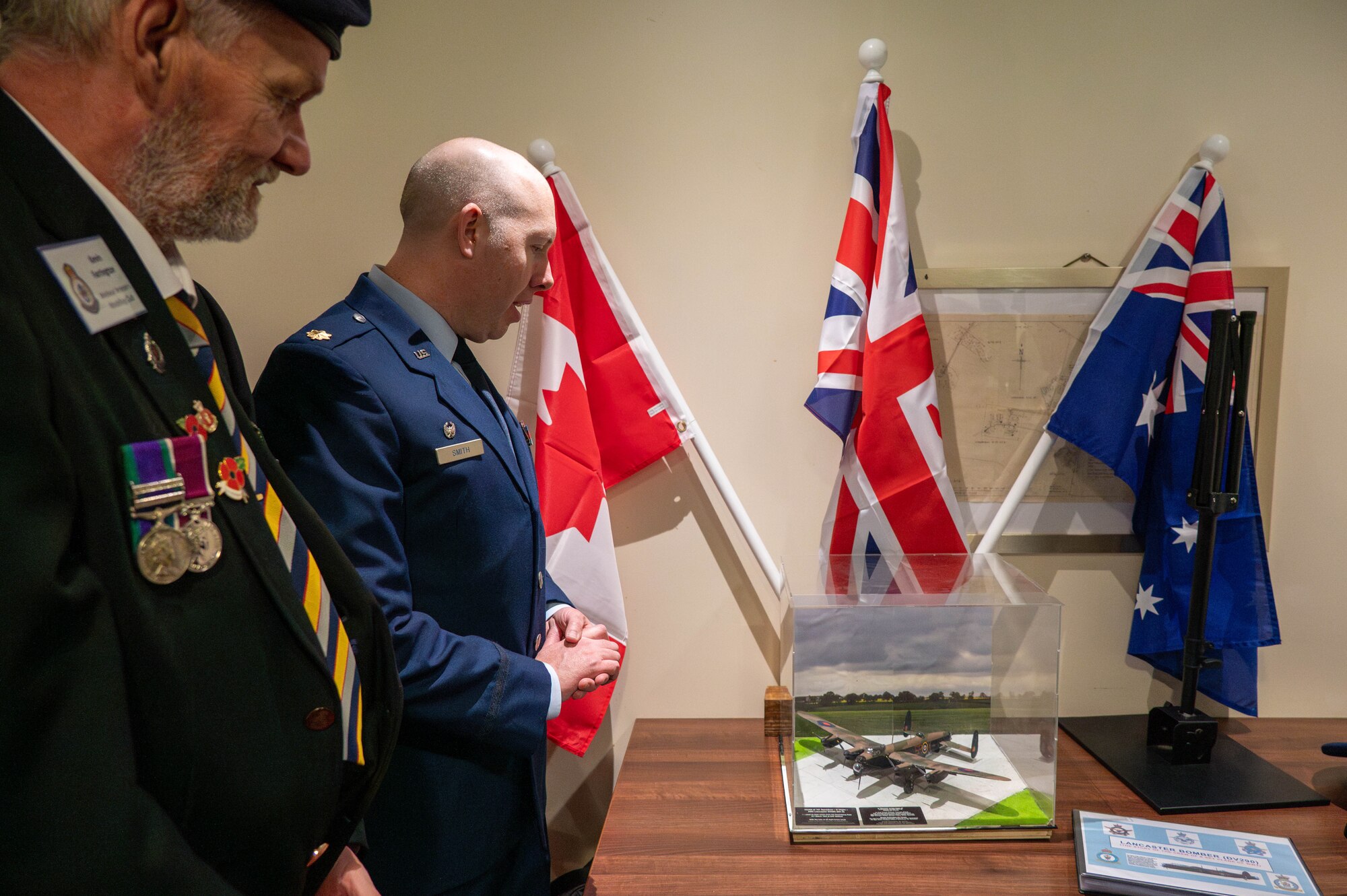 Members of the 501st Combat Support Wing and the local community admire a model Lancaster DV290.