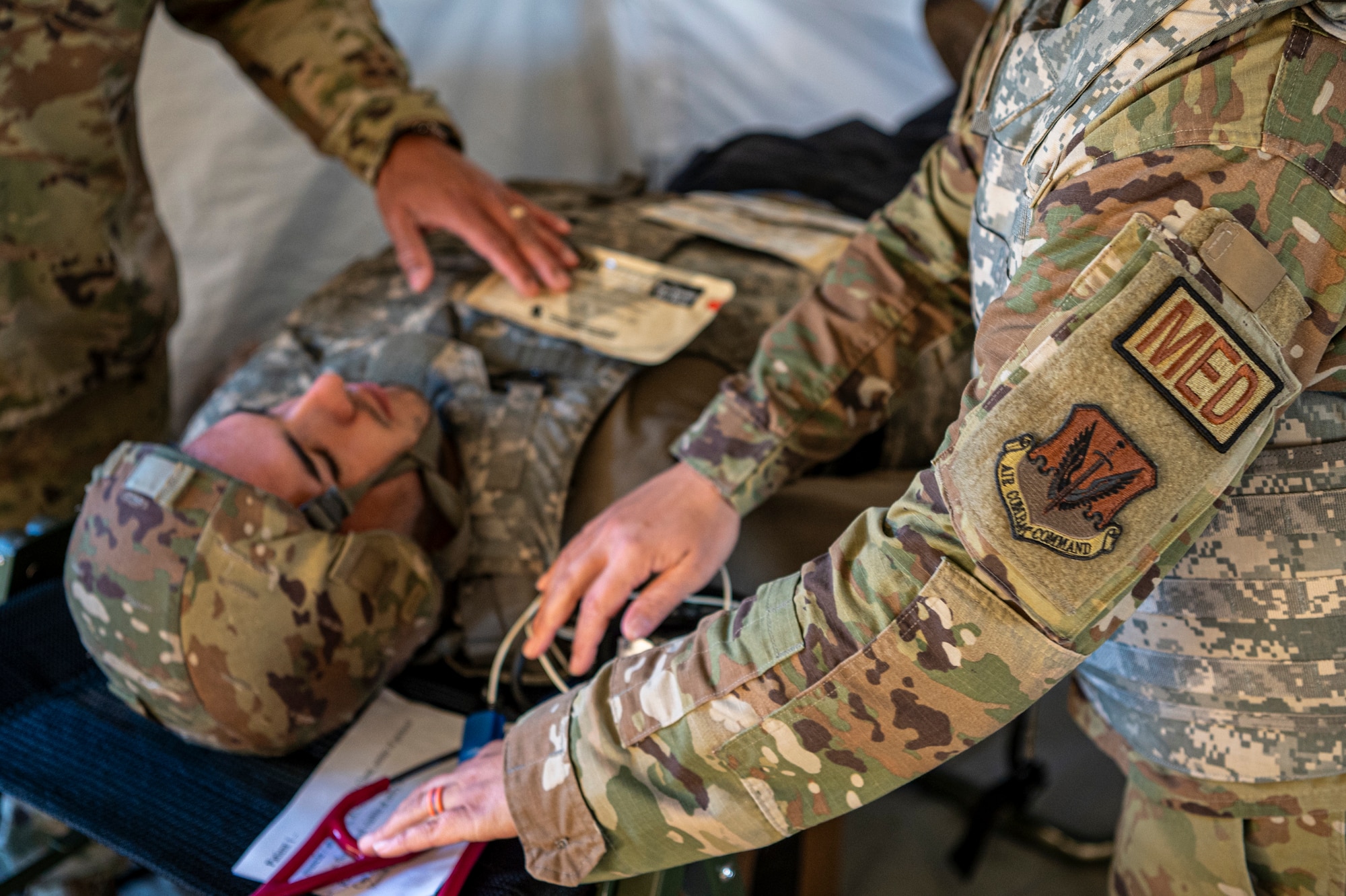 U.S. Air Force Maj. Stacy Madden, 23rd Medical Group beneficiary care clinic flight commander, assesses a simulated casualty during Exercise Ready Tiger 24-1 at Avon Park Air Force Range, Florida, April 14, 2024. Medical personnel triaged and simulated care for multiple casualties of an air and ground attack on the contingency location. Built upon Air Combat Command's directive to assert air power in contested environments, Exercise Ready Tiger 24-1 aims to test and enhance the 23rd Wing’s proficiency in executing Lead Wing and Expeditionary Air Base concepts through Agile Combat Employment and command and control operations. (U.S. Air Force photo by Airman 1st Class Leonid Soubbotine)