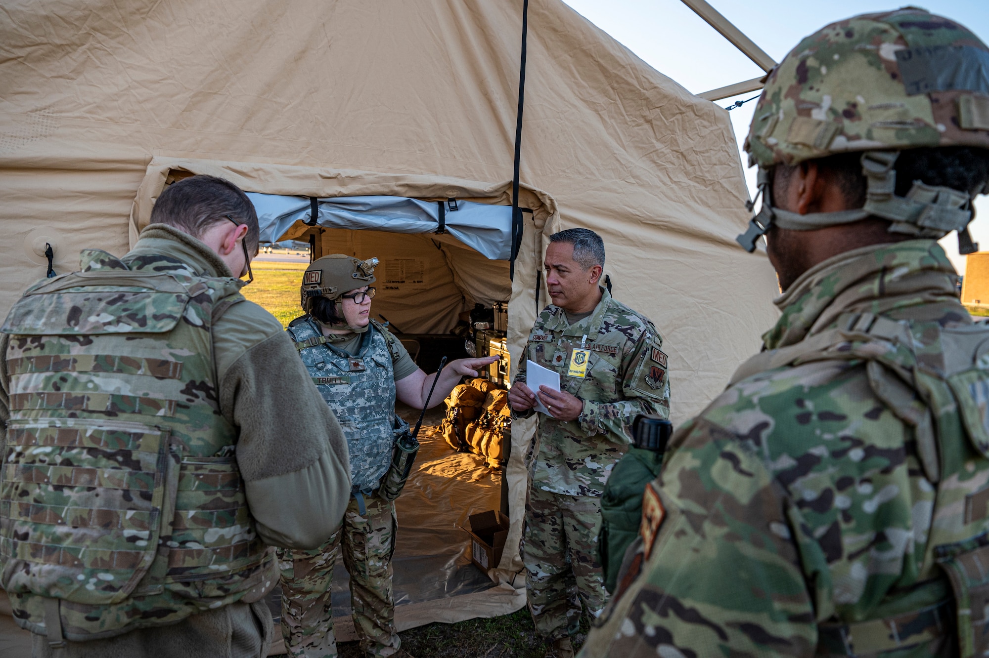 U.S. Air Force Maj. Sara Truitt, 23rd Medical Group flight commander of education and training, talks to Maj. Chris Conover, 23rd MDG health care integrator, during Exercise Ready Tiger 24-1 at Avon Park Air Force Range, Florida, April 14, 2024. Medical personnel triaged and simulated care for multiple casualties of an air and ground attack on a contingency location. Ready Tiger 24-1 is a readiness exercise demonstrating the 23rd Wing’s ability to plan, prepare and execute operations and maintenance to project air power in contested and dispersed locations, defending the United States’ interests and allies. (U.S. Air Force photo by Airman 1st Class Leonid Soubbotine)